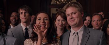 Movie still from “Bridesmaids” (2011), directed by Paul Feig – A group of people standing next to each other in a room; Medium shot, Over the shoulder angle