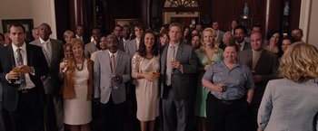 Movie still from “Bridesmaids” (2011), directed by Paul Feig – A group of people standing in front of each other holding drinks; Wide shot, High angle