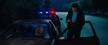 Movie still from “Bridesmaids” (2011), directed by Paul Feig – A police officer talking to a woman in a car; Medium shot, Over the shoulder angle