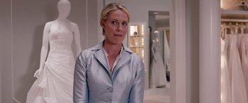 Movie still from “Bridesmaids” (2011), directed by Paul Feig – A woman standing in front of a mirror in a room; Medium shot, Over the shoulder angle