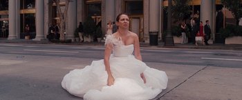 Movie still from “Bridesmaids” (2011), directed by Paul Feig – A woman sitting on the ground wearing a wedding dress; Wide shot, High angle