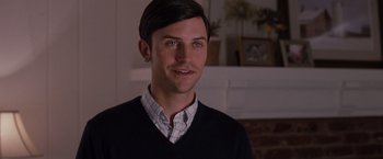Movie still from “Bridesmaids” (2011), directed by Paul Feig – A young man in a black sweater and a checkered shirt; Close Up shot, Over the shoulder angle