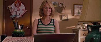 Movie still from “Bridesmaids” (2011), directed by Paul Feig – A woman sitting in front of a laptop computer; Medium shot, Over the shoulder angle
