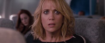 Movie still from “Bridesmaids” (2011), directed by Paul Feig – A person wearing a black shirt; Close Up shot, Over the shoulder angle
