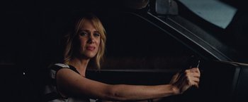 Movie still from “Bridesmaids” (2011), directed by Paul Feig – A woman driving a car in the dark; Close Up shot, Over the shoulder angle