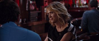Movie still from “Bridesmaids” (2011), directed by Paul Feig – A woman sitting at a table in front of other people; Close Up shot, Over the shoulder angle