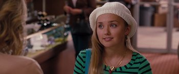 Movie still from “Bridesmaids” (2011), directed by Paul Feig – A woman with a white hat is sitting in a room; Close Up shot, Over the shoulder angle