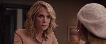 Movie still from “Bridesmaids” (2011), directed by Paul Feig – A person wearing a shirt; Close Up shot, Over the shoulder angle