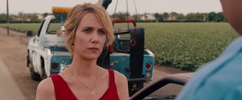 Movie still from “Bridesmaids” (2011), directed by Paul Feig – A woman standing next to a truck on a road; Close Up shot, Over the shoulder angle