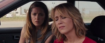 Movie still from “Bridesmaids” (2011), directed by Paul Feig – Two women sitting in the back seat of a car; Close Up shot, Over the shoulder angle