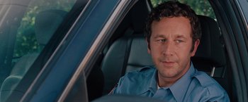 Movie still from “Bridesmaids” (2011), directed by Paul Feig – A man sitting in the drivers seat of a police car; Close Up shot, Over the shoulder angle