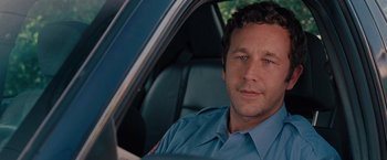 Movie still from “Bridesmaids” (2011), directed by Paul Feig – A man sitting in the driver's seat of a police car; Close Up shot, Over the shoulder angle