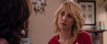 Movie still from “Bridesmaids” (2011), directed by Paul Feig – A woman in a red shirt is looking to her left; Close Up shot, Over the shoulder angle