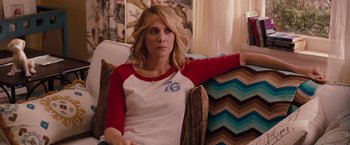 Movie still from “Bridesmaids” (2011), directed by Paul Feig – A woman sitting on a couch in a room; Medium shot, Over the shoulder angle