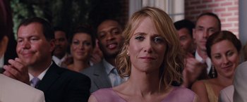 Movie still from “Bridesmaids” (2011), directed by Paul Feig – A group of people standing next to each other in a room; Close Up shot, Over the shoulder angle