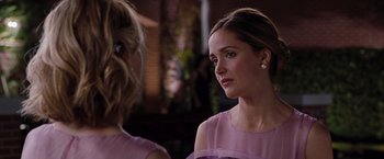 Movie still from “Bridesmaids” (2011), directed by Paul Feig – A woman in a pink dress talking to another woman in a pink dress; Close Up shot, Over the shoulder angle