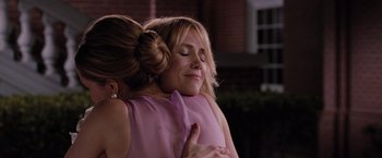 Movie still from “Bridesmaids” (2011), directed by Paul Feig – Two women embracing each other in front of a building; Close Up shot, Over the shoulder angle