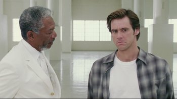 Movie still from “Bruce Almighty” (2003), directed by Tom Shadyac – A man and an older man standing next to each other in an empty room; Close Up shot, Low angle