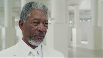 Movie still from “Bruce Almighty” (2003), directed by Tom Shadyac – An older black man in a white suit and tie; Close Up shot, Over the shoulder angle