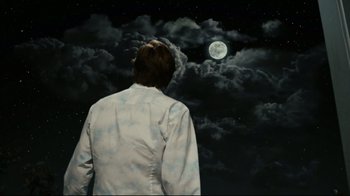 Movie still from “Bruce Almighty” (2003), directed by Tom Shadyac – A man standing in front of a full moon; Medium shot, Low angle