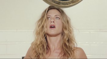 Movie still from “Bruce Almighty” (2003), directed by Tom Shadyac – A woman with long blonde hair looking up at a mirror; Close Up shot, Overhead angle