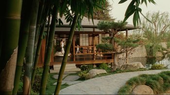 Movie still from “Bruce Almighty” (2003), directed by Tom Shadyac – A person sitting on the porch of a house; Extreme Wide shot, High angle