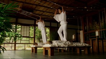 Movie still from “Bruce Almighty” (2003), directed by Tom Shadyac – A couple of people that are standing up in a room; Wide shot, Low angle