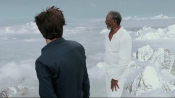 Movie still from “Bruce Almighty” (2003), directed by Tom Shadyac – Two men standing in front of a sky filled with fluffy clouds; Medium shot, Over the shoulder angle
