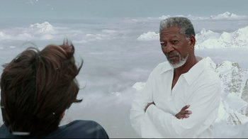 Movie still from “Bruce Almighty” (2003), directed by Tom Shadyac – A man standing next to a woman on a cloudy day; Close Up shot, Over the shoulder angle