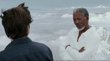 Movie still from “Bruce Almighty” (2003), directed by Tom Shadyac – A man standing next to another man on a cloudy day; Close Up shot, Over the shoulder angle
