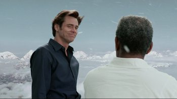 Movie still from “Bruce Almighty” (2003), directed by Tom Shadyac – Two men are talking to each other in a field; Medium shot, Over the shoulder angle