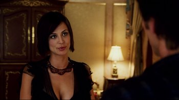 Movie still from “Bruce Almighty” (2003), directed by Tom Shadyac – A beautiful woman in a black dress posing for a picture; Close Up shot, Over the shoulder angle