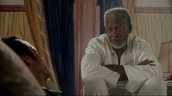 Movie still from “Bruce Almighty” (2003), directed by Tom Shadyac – An older man sitting in front of a mirror; Medium shot, Over the shoulder angle