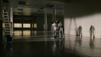 Movie still from “Bruce Almighty” (2003), directed by Tom Shadyac – Two men are cleaning the floor in a large room; Extreme Wide shot, High angle