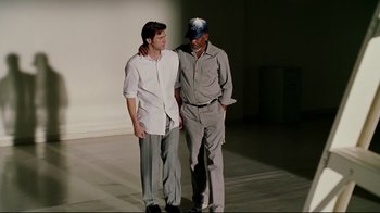 Movie still from “Bruce Almighty” (2003), directed by Tom Shadyac – A couple of men standing next to each other; Medium shot, Low angle