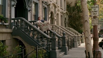 Movie still from “Bruce Almighty” (2003), directed by Tom Shadyac – A man sitting on the steps of an apartment building; Wide shot, High angle