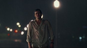 Movie still from “Bruce Almighty” (2003), directed by Tom Shadyac – A man standing in the dark near a street light; Medium shot, Over the shoulder angle