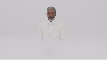 Movie still from “Bruce Almighty” (2003), directed by Tom Shadyac – An older man wearing a white suit and tie; Medium shot, Low angle