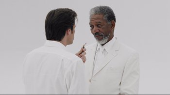 Movie still from “Bruce Almighty” (2003), directed by Tom Shadyac – A man in a white suit looking at himself in the mirror; Close Up shot, Over the shoulder angle