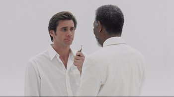 Movie still from “Bruce Almighty” (2003), directed by Tom Shadyac – Two men in white shirts one of which is holding a tooth brush; Close Up shot, Over the shoulder angle
