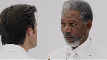 Movie still from “Bruce Almighty” (2003), directed by Tom Shadyac – A man in a white suit talking to a man in a white suit; Close Up shot, Over the shoulder angle