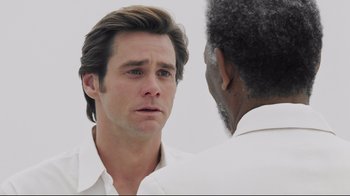 Movie still from “Bruce Almighty” (2003), directed by Tom Shadyac – A man in white shirt looking at another man in white shirt; Close Up shot, Over the shoulder angle