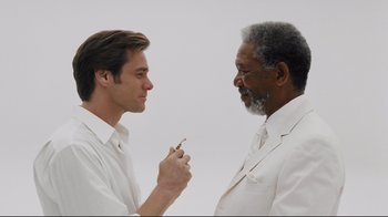 Movie still from “Bruce Almighty” (2003), directed by Tom Shadyac – Two men in white shirts and white ties talking to each other; Close Up shot, Low angle