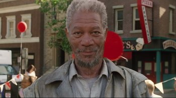 Movie still from “Bruce Almighty” (2003), directed by Tom Shadyac – An older man with grey hair and a gray shirt; Close Up shot, Over the shoulder angle