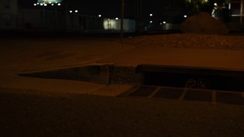 Movie still from “Better Call Saul” (2015), created by Vince Gilligan – A night view of a city street with lights; Wide shot, High angle