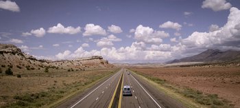 Movie still from “Chambers” (2019), created by Leah Rachel – A car driving down the middle of a highway; Extreme Wide shot, Low angle