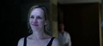 Movie still from “Chambers” (2019), created by Leah Rachel – A person with a person in the background; Close Up shot, Over the shoulder angle