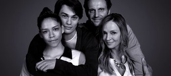 Movie still from “Chambers” (2019), created by Leah Rachel – A black and white photo of four people posing for a picture; Close Up shot, Overhead angle