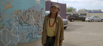 Movie still from “Chambers” (2019), created by Leah Rachel – An older man standing on the side of the street; Medium shot, Over the shoulder angle