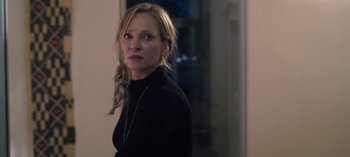 Movie still from “Chambers” (2019), created by Leah Rachel – A woman in a black shirt is standing in a room; Close Up shot, Over the shoulder angle